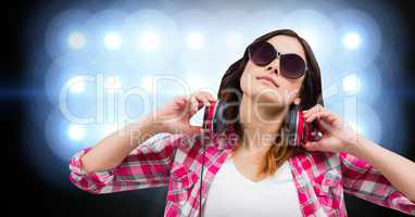 Female hipster with headphones against bright background