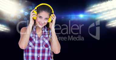 Smiling woman listening to music on headphones