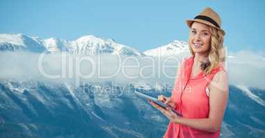 Woman using tablet PC against mountains