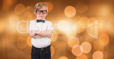 Little boy standing arms crossed over bokeh