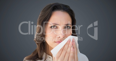 Close up of woman with tissue against grey background