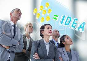 Business people looking at lightbulb doodle against blurry grey office