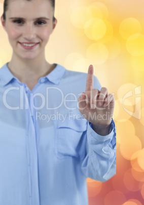 Smiling businesswoman touching screen over bokeh