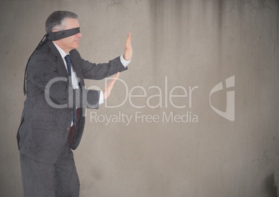 Business man blindfolded with grunge overlay against brown background