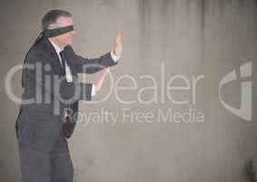 Business man blindfolded with grunge overlay against brown background