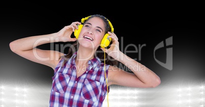 Happy woman listening to songs on headphones