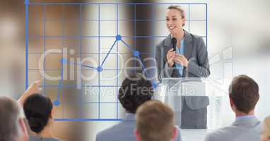 Businesswoman giving speech to colleagues by graph