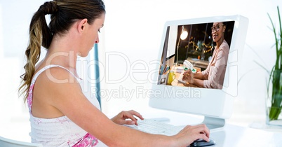 Side view of woman video conferencing on computer