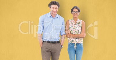 Confident business people standing against yellow background