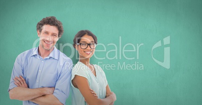 Portrait of smiling business people standing arms crossed against green background