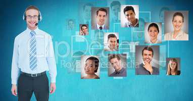 Smiling male customer care representative standing by flying portraits