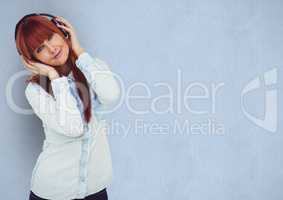 Redhead woman wearing headphones over blue background