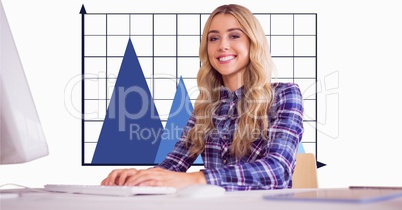 Smiling businesswoman against graph in office