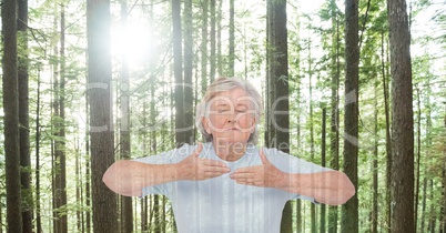 Double exposure senior woman meditating in forest