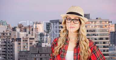 Female hipster wearing eyeglasses and sunhat in city