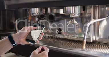 Hand photographing coffee cup on smart phone
