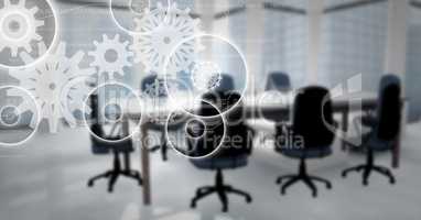 White gear graphics against blurry meeting room