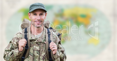 Soldier with backpack against blurry map