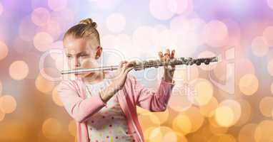 Girl playing flute over bokeh