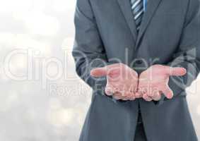 Midsection of businessman holding invisible product