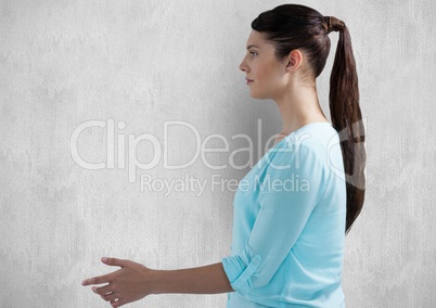 Side view of woman gesturing over wall