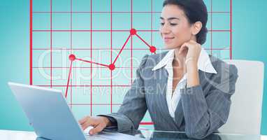 Businesswoman using laptop with graph in background