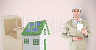 Delivery man holding card by 3d house and parcels