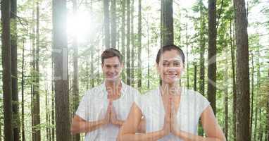 Double exposure of man and woman with hands clasped in forest