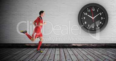 Sportsman running by clock on wall