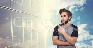 Hipster smoking pipe by modern building