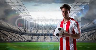 Soccer player holding ball at stadium