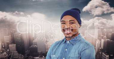Smiling man wearing knit hat against cityscape