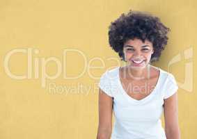 Happy female hipster with curly hair over yellow background