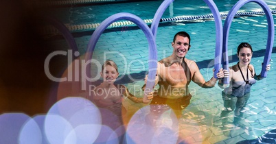 Smiling man and women with inflatable sticks in pool
