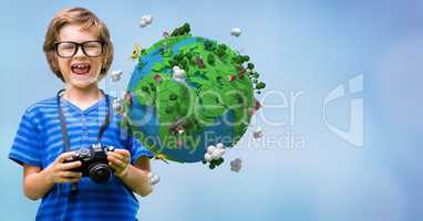 Happy boy holding camera by low poly earth