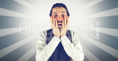 Surprised man with hands on cheeks against bright background