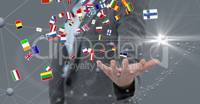 Various flags flying over business person's hand