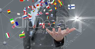 Various flags flying over business person's hand