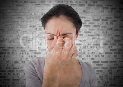 Woman stressed against white brick wall with grunge overlay