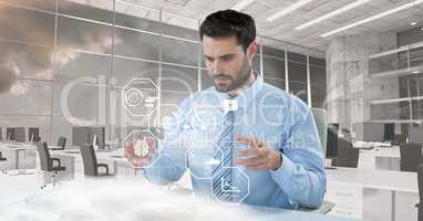 Digital composite image of businessman standing at futuristic desk