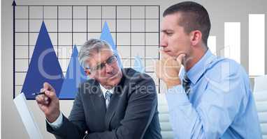 Businessmen discussing against graph in office