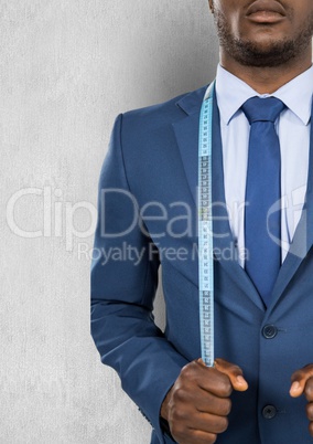 Midsection of businessman with measuring tape