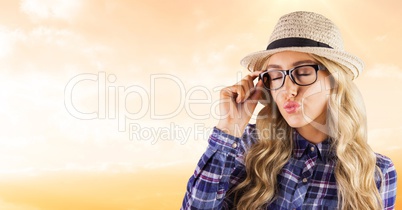 Female hipster wearing eyeglasses while puckering lips