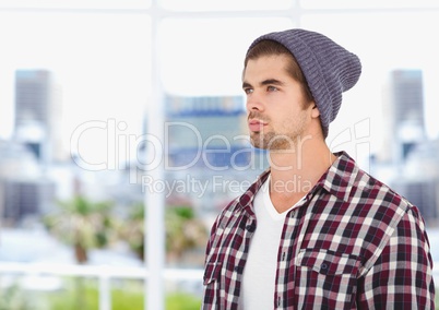 Male hipster wearing knit hat while looking away