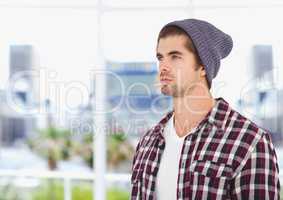 Male hipster wearing knit hat while looking away