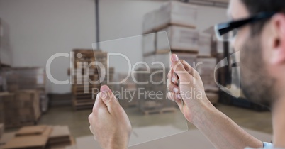 Hands photographing through transparent device in warehouse