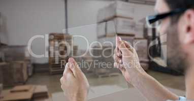 Hands photographing through transparent device in warehouse