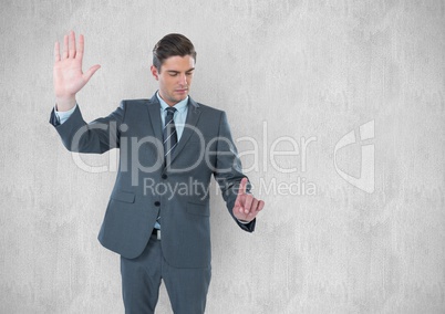 Young businessman gesturing against wall