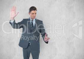 Young businessman gesturing against wall