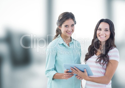 Smiling businesswomen with tablet PC in office